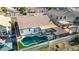 Aerial shot of backyard featuring a pool, covered patio, turf and privacy fence at 11622 W Palm Brook Dr, Avondale, AZ 85392
