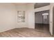 Empty bedroom with wood-style flooring, arched transom, and an open doorway at 11622 W Palm Brook Dr, Avondale, AZ 85392