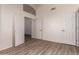 Bedroom with tile flooring, arched transom, three doors, and neutral walls at 11622 W Palm Brook Dr, Avondale, AZ 85392