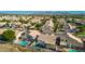 Aerial view of a well-planned residential community with mature trees and neighborhood pools at 11622 W Palm Brook Dr, Avondale, AZ 85392