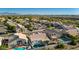 Wide aerial shot showcasing a well-kept residential community with mountain views and mature landscaping at 11622 W Palm Brook Dr, Avondale, AZ 85392