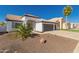 This charming single-story home features a desert landscape, a two-car garage, and lush curb appeal at 11622 W Palm Brook Dr, Avondale, AZ 85392