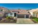 Charming home featuring a well-manicured front yard, mature landscaping, and a spacious driveway at 11622 W Palm Brook Dr, Avondale, AZ 85392
