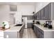 Modern kitchen featuring gray cabinets, stainless steel appliances, granite countertops, and recessed lighting at 11622 W Palm Brook Dr, Avondale, AZ 85392