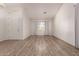 Bright and airy living room boasts high ceilings and beautiful wood-style flooring at 11622 W Palm Brook Dr, Avondale, AZ 85392