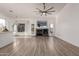 Open-concept living area featuring a cozy fireplace and seamless transition to the kitchen at 11622 W Palm Brook Dr, Avondale, AZ 85392