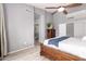 Inviting main bedroom with ceiling fan, and decorative wooden bed frame with bedside lamps at 11622 W Palm Brook Dr, Avondale, AZ 85392