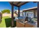 A lush backyard with a pristine pool and an outdoor kitchen with a built-in gas grill at 11622 W Palm Brook Dr, Avondale, AZ 85392