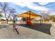 Fun community playground with colorful equipment and a shaded area, great for children to play and socialize at 11622 W Palm Brook Dr, Avondale, AZ 85392