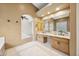 Bright bathroom boasts double vanity with granite counters and decorative tile flooring at 11816 E Terra Dr, Scottsdale, AZ 85259