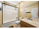 Bathroom featuring granite counters and a tub/shower combo with glass doors at 11816 E Terra Dr, Scottsdale, AZ 85259