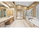 Bright bathroom boasts double vanity, glass shower, and soaking tub with decorative tile surround at 11816 E Terra Dr, Scottsdale, AZ 85259