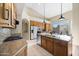 An updated kitchen with stainless appliances, granite countertops and tile flooring at 11816 E Terra Dr, Scottsdale, AZ 85259