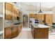 A modern eat-in kitchen featuring granite counters, stainless appliances, tile floors and backyard access at 11816 E Terra Dr, Scottsdale, AZ 85259
