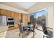 Well-lit eat-in kitchen boasts tile floors, modern lighting, and backyard views at 11816 E Terra Dr, Scottsdale, AZ 85259