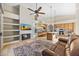 Open-concept living area has a fireplace, shelving, TV, and a kitchen with an island at 11816 E Terra Dr, Scottsdale, AZ 85259