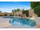 Beautiful pool with a rock waterfall feature, providing a serene and luxurious backyard oasis at 11816 E Terra Dr, Scottsdale, AZ 85259