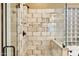 Glass shower with tile surround and chrome fixtures in home bathroom at 11816 E Terra Dr, Scottsdale, AZ 85259