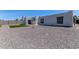 Back exterior view of home with gravel landscape, turf patch, and block wall at 13012 N 36Th Dr, Phoenix, AZ 85029