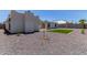 Backyard view featuring rock landscaping and turf patch with young tree at 13012 N 36Th Dr, Phoenix, AZ 85029
