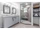 Bright bathroom features double sinks, gray cabinets, and a glass-enclosed shower at 13012 N 36Th Dr, Phoenix, AZ 85029