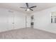 A bedroom with light gray flooring, white walls, and a ceiling fan fixture at 13012 N 36Th Dr, Phoenix, AZ 85029