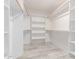 Bright walk-in closet features white shelving and hanging rods at 13012 N 36Th Dr, Phoenix, AZ 85029