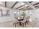 Elegant dining room with modern light fixture, wood beams, and stylish decor at 13012 N 36Th Dr, Phoenix, AZ 85029