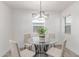 Charming dining room with glass table, modern lighting, and natural light at 13012 N 36Th Dr, Phoenix, AZ 85029