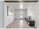 Inviting entryway with wood-look tile floors, bench seating and modern art at 13012 N 36Th Dr, Phoenix, AZ 85029