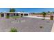 Stunning front of home featuring rock landscaping, grass patch and spacious driveway to the 2-car garage at 13012 N 36Th Dr, Phoenix, AZ 85029