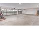 Large two-car garage with overhead doors and concrete floor at 13012 N 36Th Dr, Phoenix, AZ 85029