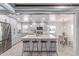 Bright kitchen features gray cabinets, stainless appliances, large island with seating, and an adjacent dining area at 13012 N 36Th Dr, Phoenix, AZ 85029