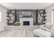 Bright living room features a brick fireplace, built-in shelving, and modern decor at 13012 N 36Th Dr, Phoenix, AZ 85029