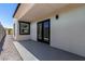 Covered patio with door, window, gray surface, and gravel landscape at 13012 N 36Th Dr, Phoenix, AZ 85029