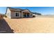 Rear exterior view of house showing covered patio and large open backyard at 13619 W Hackamore Dr, Peoria, AZ 85383