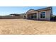 Rear exterior view of house showing covered patio and spacious backyard at 13619 W Hackamore Dr, Peoria, AZ 85383