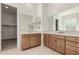 Bathroom featuring double vanities and sinks with sleek cabinetry at 13619 W Hackamore Dr, Peoria, AZ 85383