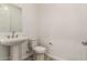 Bathroom featuring pedestal sink, mirror, toilet, and modern finishes at 13619 W Hackamore Dr, Peoria, AZ 85383
