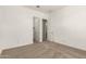 Bedroom featuring neutral carpet and two doors leading to closets and other rooms at 13619 W Hackamore Dr, Peoria, AZ 85383