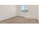 A bright bedroom with neutral carpet and a window allowing natural light at 13619 W Hackamore Dr, Peoria, AZ 85383