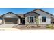 Charming single-story home featuring a front yard with rock landscaping and neutral toned exterior at 13619 W Hackamore Dr, Peoria, AZ 85383