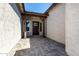 A charming front porch featuring a dark brown wood door, exposed beams, and an ample entryway at 13619 W Hackamore Dr, Peoria, AZ 85383