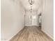 Hallway with wood floors and neutral walls leading to the front door with view of the outside at 13619 W Hackamore Dr, Peoria, AZ 85383