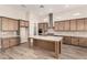 Bright kitchen features stainless steel appliances, gray backsplash, and light wood cabinets at 13619 W Hackamore Dr, Peoria, AZ 85383