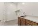A modern laundry room features a white countertop, a sink, and a set of cabinets at 13619 W Hackamore Dr, Peoria, AZ 85383