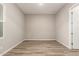 Empty room featuring wood-look flooring and natural light at 13619 W Hackamore Dr, Peoria, AZ 85383