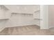 Walk-in closet with white shelving and a carpeted floor at 13619 W Hackamore Dr, Peoria, AZ 85383