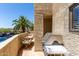 Cozy outdoor balcony with chairs, a table, a grill, and palm tree views, perfect for relaxing at 1401 E Puget Ave # 10, Phoenix, AZ 85020