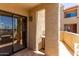 Cozy balcony with stucco wall, sliding glass door, and partial view, offering a private retreat at 1401 E Puget Ave # 10, Phoenix, AZ 85020
